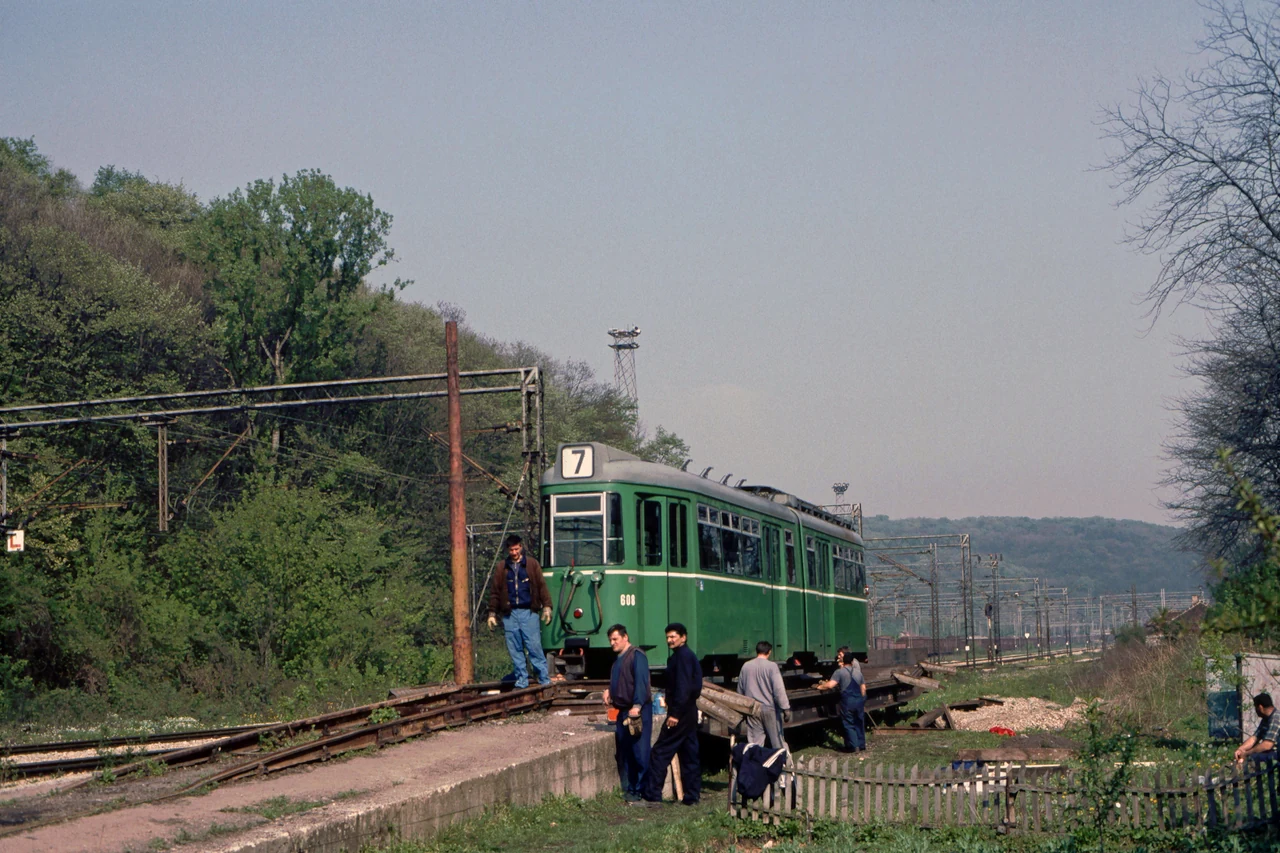 People beside the tram and tracks.