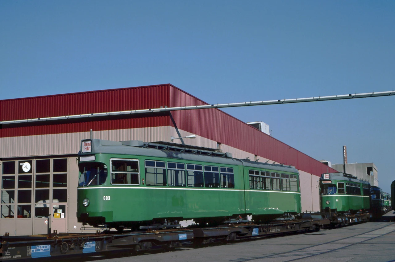 Trams beside a depot building.